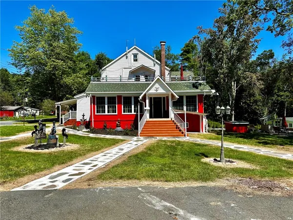 a front view of a house with a yard table and chairs
