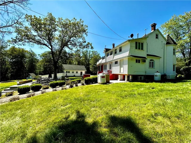 a backyard of a house with table and chairs