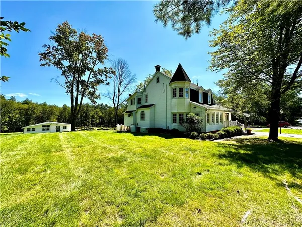 a front view of a house with yard and green space
