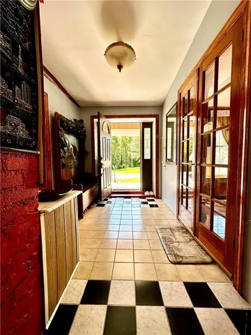 a view of a entryway door with a rug