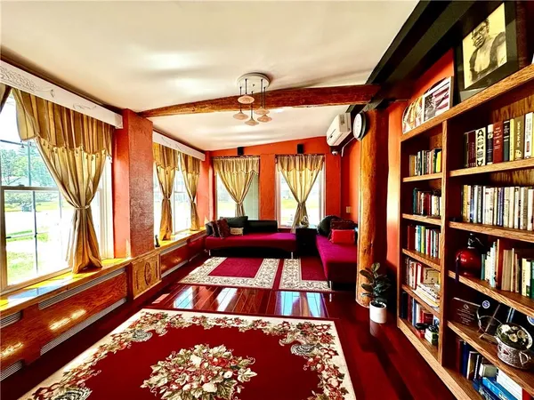 a bedroom with furniture and a book shelf