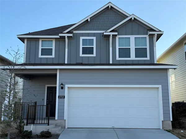 a yard that is sitting in front of a house