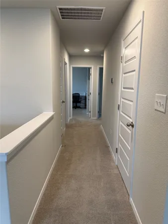 a view of a hallway with closet and entryway