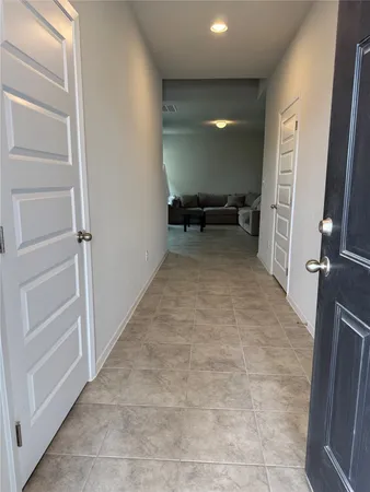 a view of a hallway to rooms and stairs