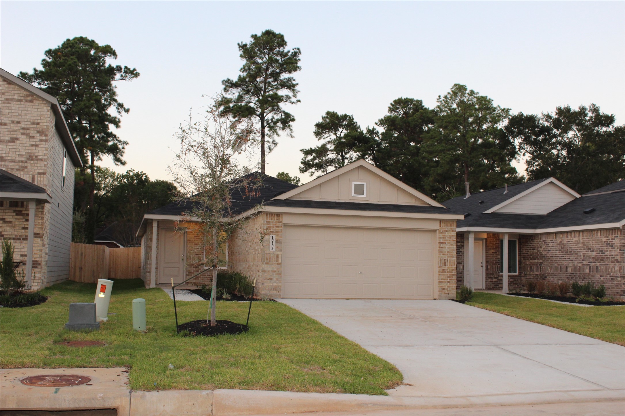 1733 Lofty Cedar Court Conroe, TX 77301 - Photo 1 of 18 a front view of a house with garden
