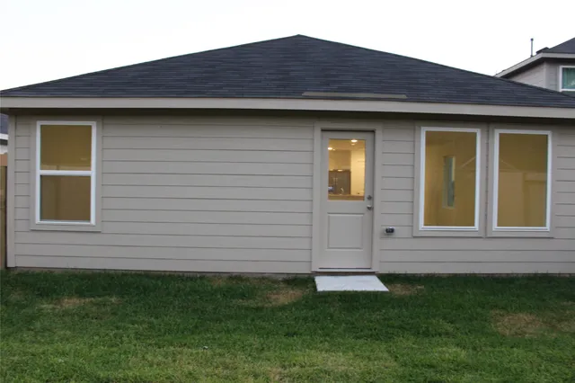 a view of house with backyard