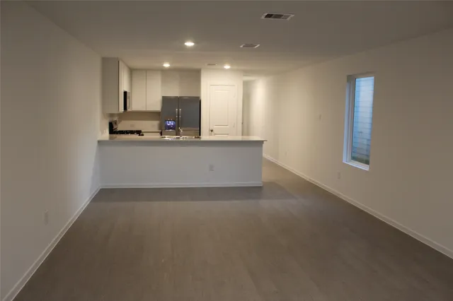 a view of kitchen with kitchen island sink and center island