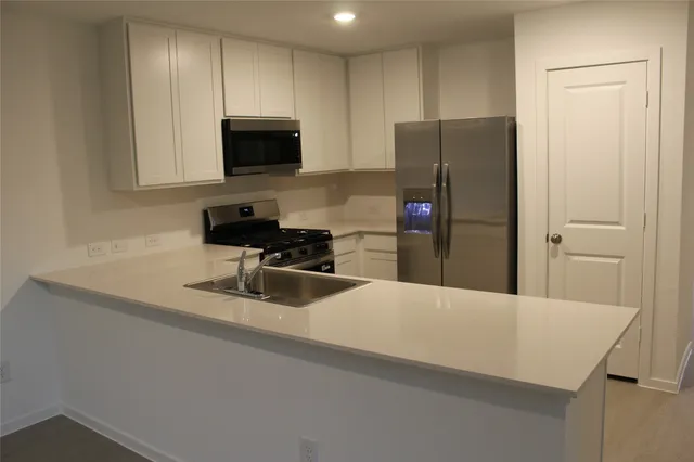 a kitchen with a refrigerator and a sink
