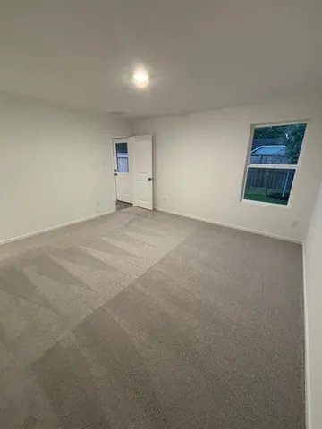 a view of an empty room and a window