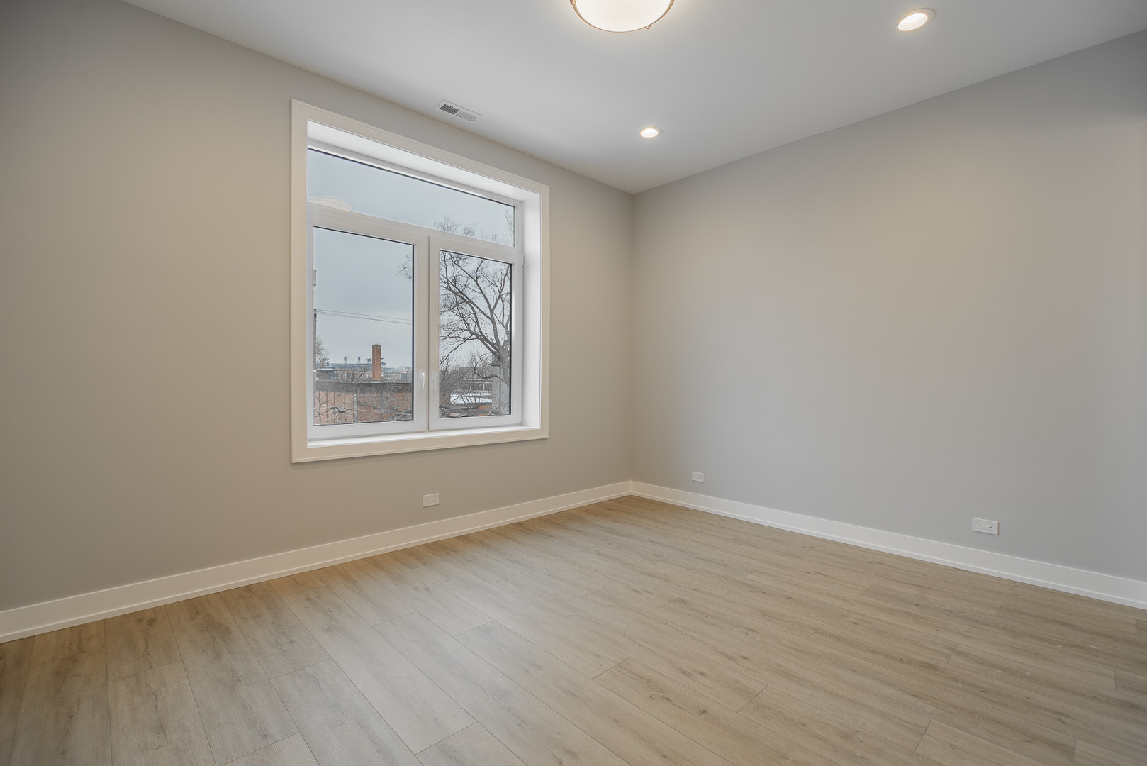 3738 South Calumet Avenue, Unit 2N Chicago, IL 60653 - Photo 11 of 21 a view of an empty room with wooden floor and a window