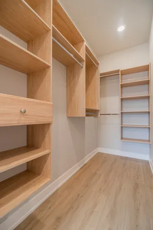 a view of a room with wooden floor closet and windows
