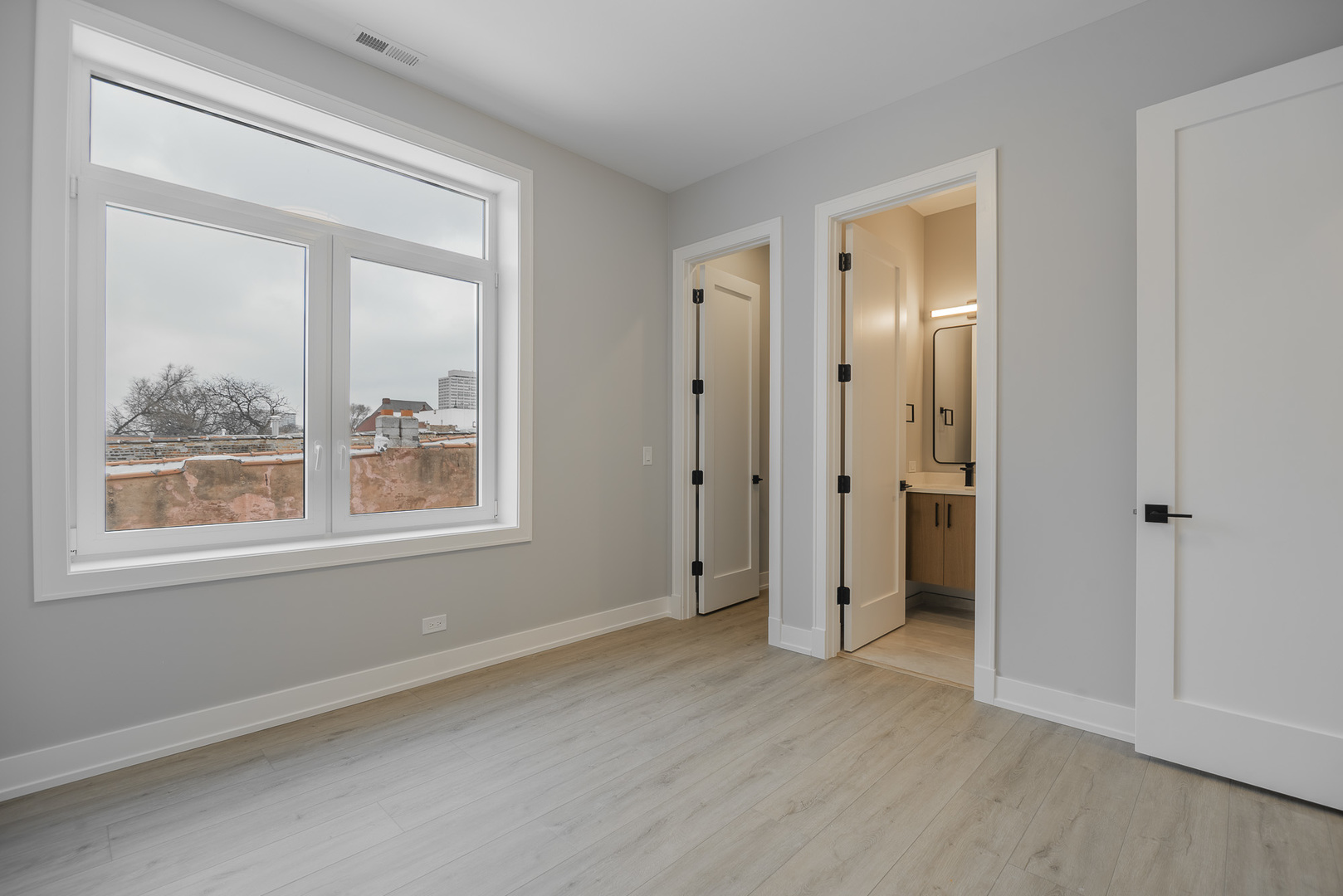 3738 South Calumet Avenue, Unit 2N Chicago, IL 60653 - Photo 17 of 21 an empty room with a window and wooden floor