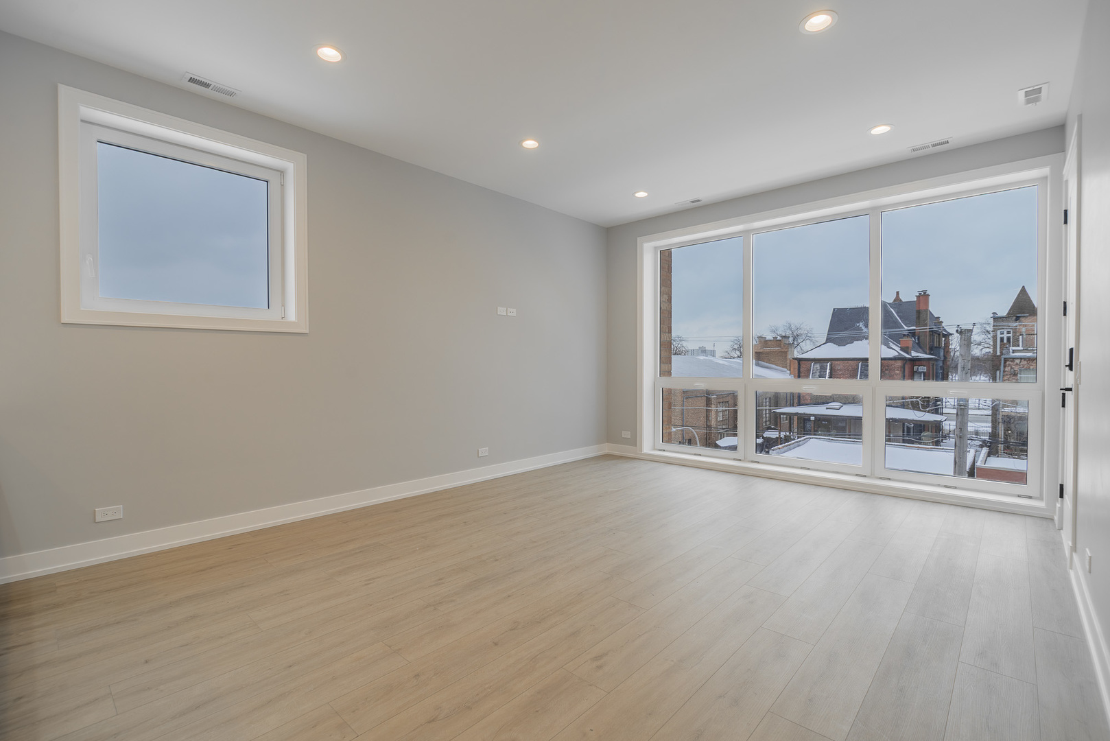 3738 South Calumet Avenue, Unit 2N Chicago, IL 60653 - Photo 3 of 21 a view of a big room with wooden floor white walls and windows