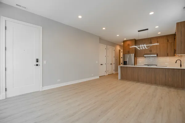a view of kitchen with kitchen island and wooden floor