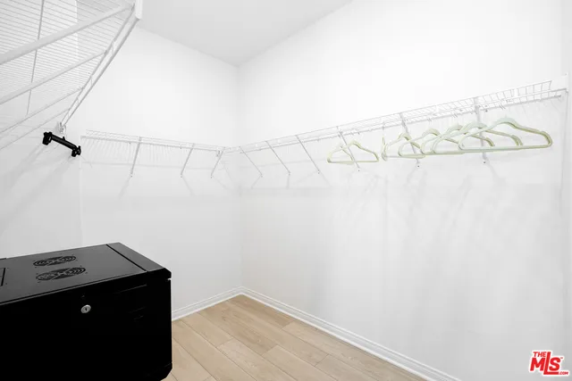 a bedroom with bed and wooden floor