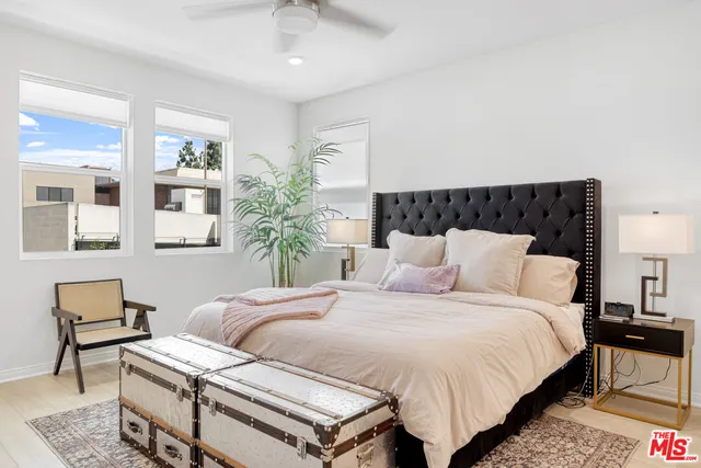 a bedroom with a bed and a potted plant