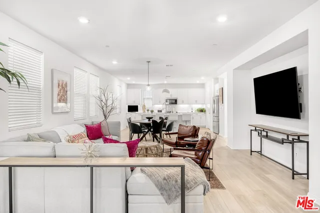 a living room with furniture and kitchen view