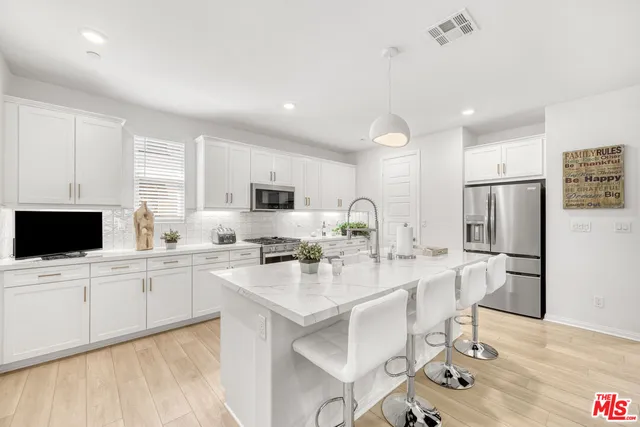 a kitchen with stainless steel appliances a stove a microwave and cabinets