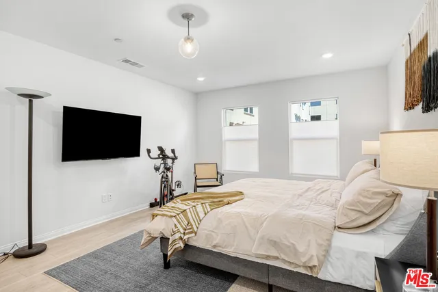 a bathroom with a sink toilet vanity and shower