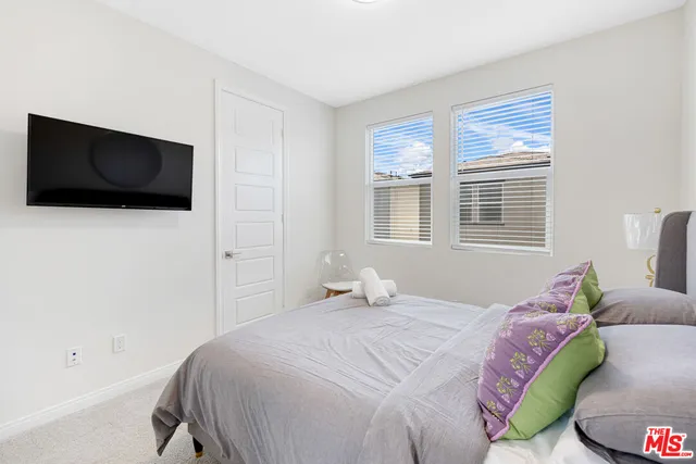 a bathroom with a sink a toilet and a large mirror