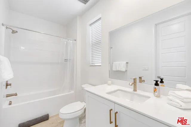 a bedroom with bed and a mirror