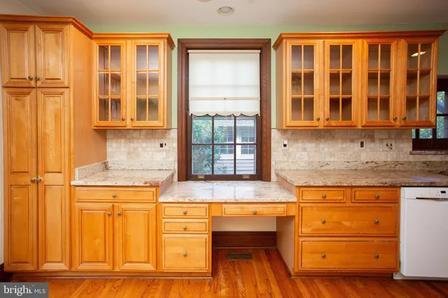 a kitchen with stainless steel appliances granite countertop a stove and cabinets