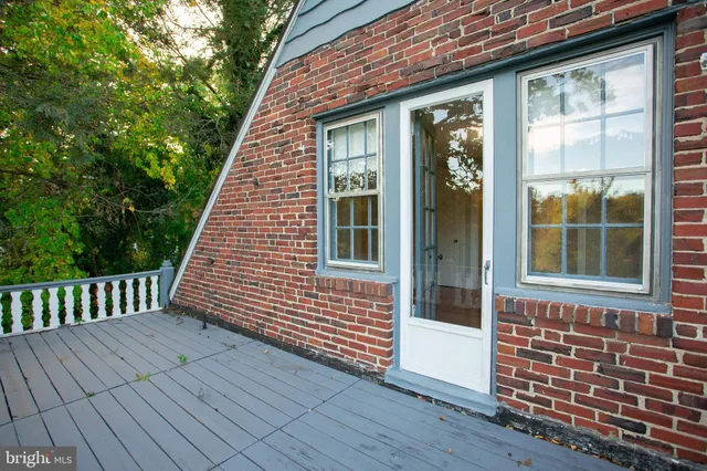 a view of front door of house with deck