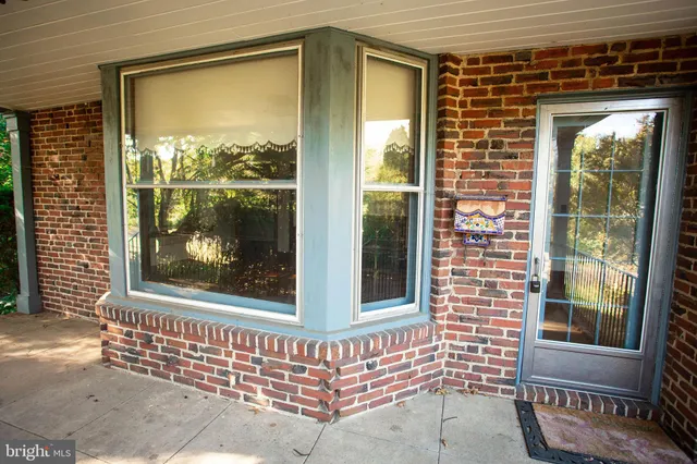 a view of a brick house with large windows