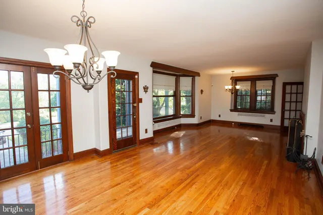 a view of a room with wooden floor and large windows