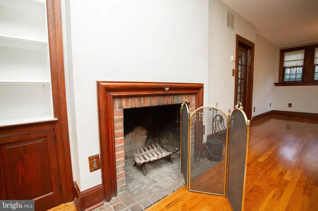 a view of living room with furniture and a fireplace