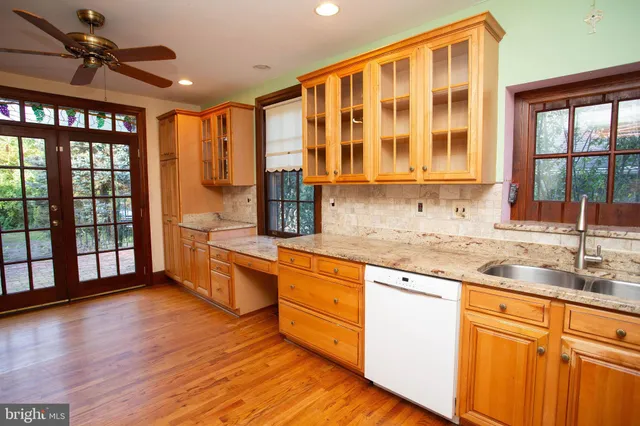 a kitchen with stainless steel appliances granite countertop a stove and cabinets