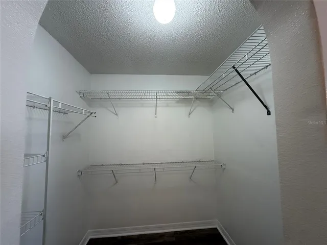 a view of storage and utility room with racks on the wall