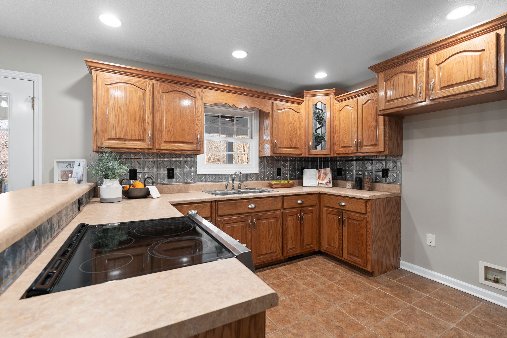 954 Newt Vanattia Road Hillsboro, TN 37342 - Photo 13 of 42 a kitchen with granite countertop a sink stove and cabinets