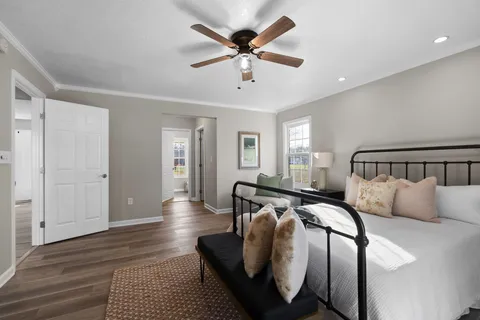 a bedroom with bed and a chandelier