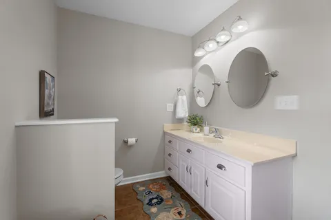 a bathroom with a double vanity sink and a mirror