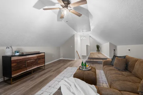 a living room with furniture and a fireplace