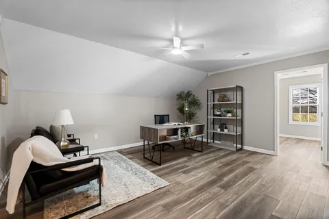 a living room with furniture and a wooden floor