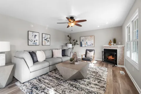 a living room with furniture fireplace and window