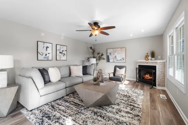 a living room with furniture fireplace and window