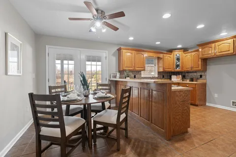 a dining table with chairs and kitchen view