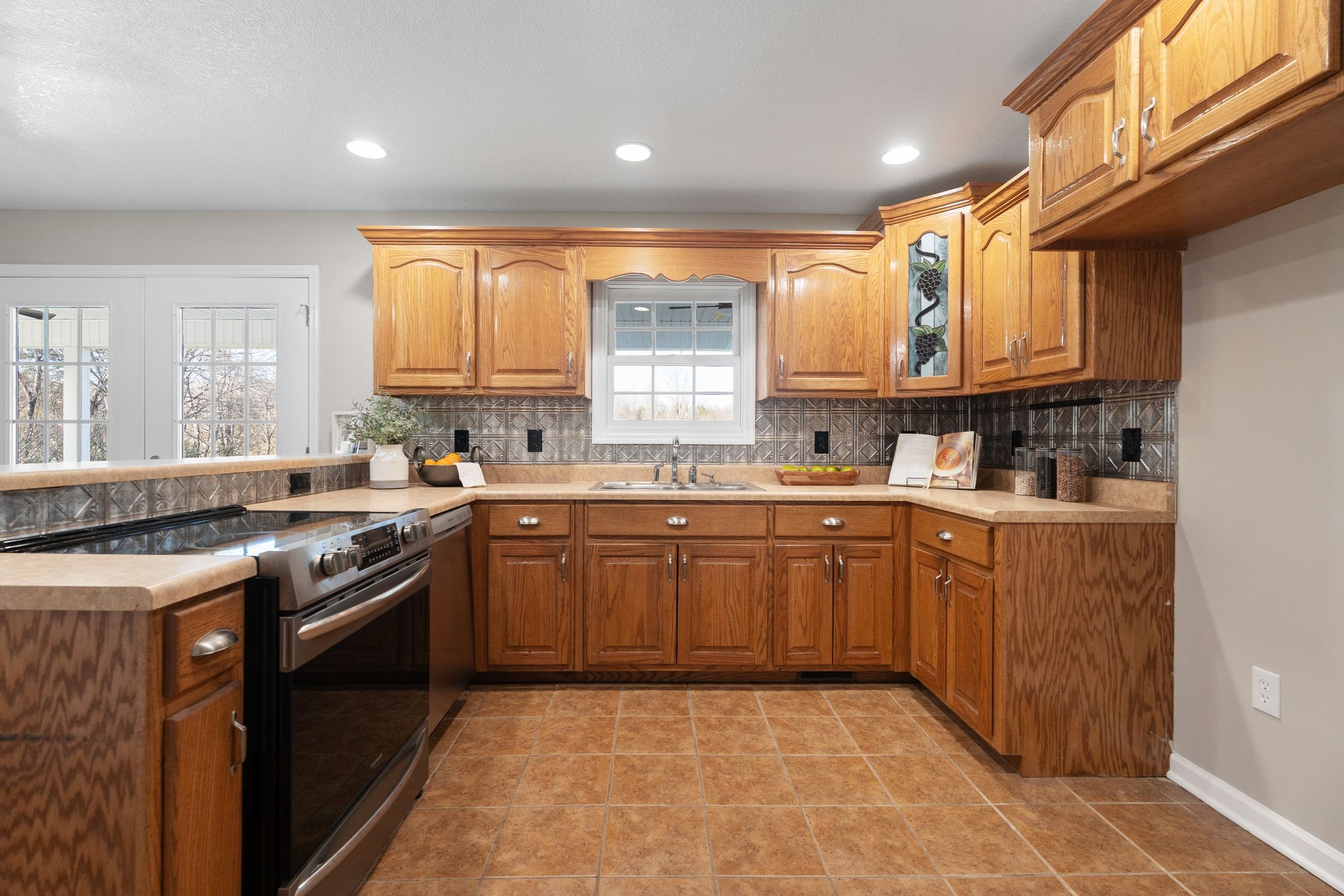 954 Newt Vanattia Road Hillsboro, TN 37342 - Photo 10 of 42 a kitchen with a sink stove top oven and cabinets