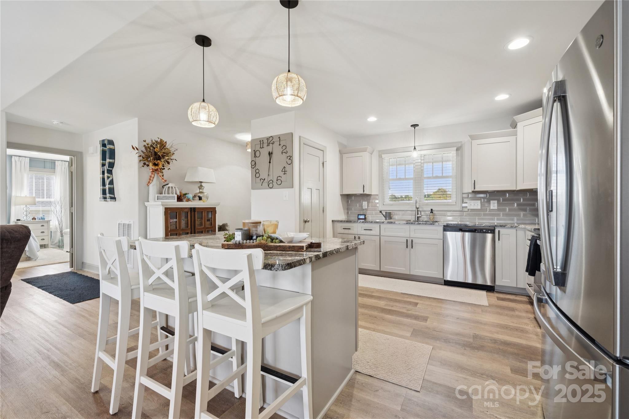 142 Alf Hoover Road Lincolnton, NC 28092 - Photo 12 of 40 a kitchen with stainless steel appliances granite countertop a sink a stove a refrigerator and island with wooden floor