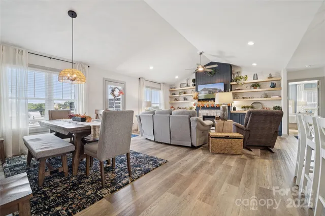 a living room with lots of furniture and kitchen view