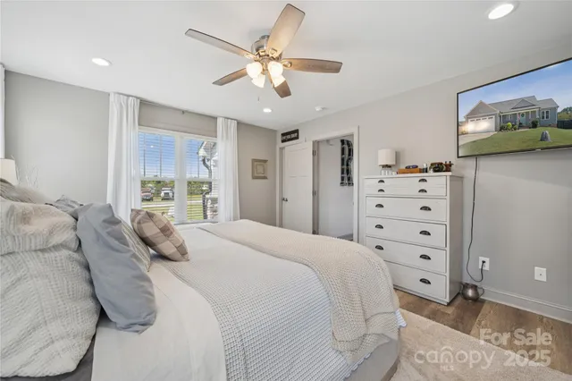 a bedroom with a large bed and a window