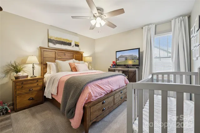 a bedroom with a bed and a chandelier