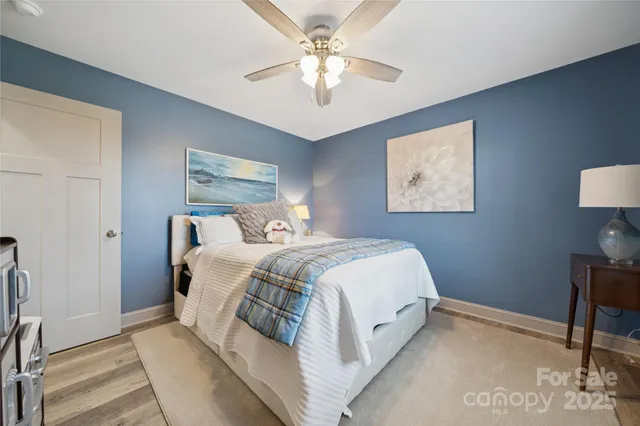 a bedroom with a bed and a chandelier