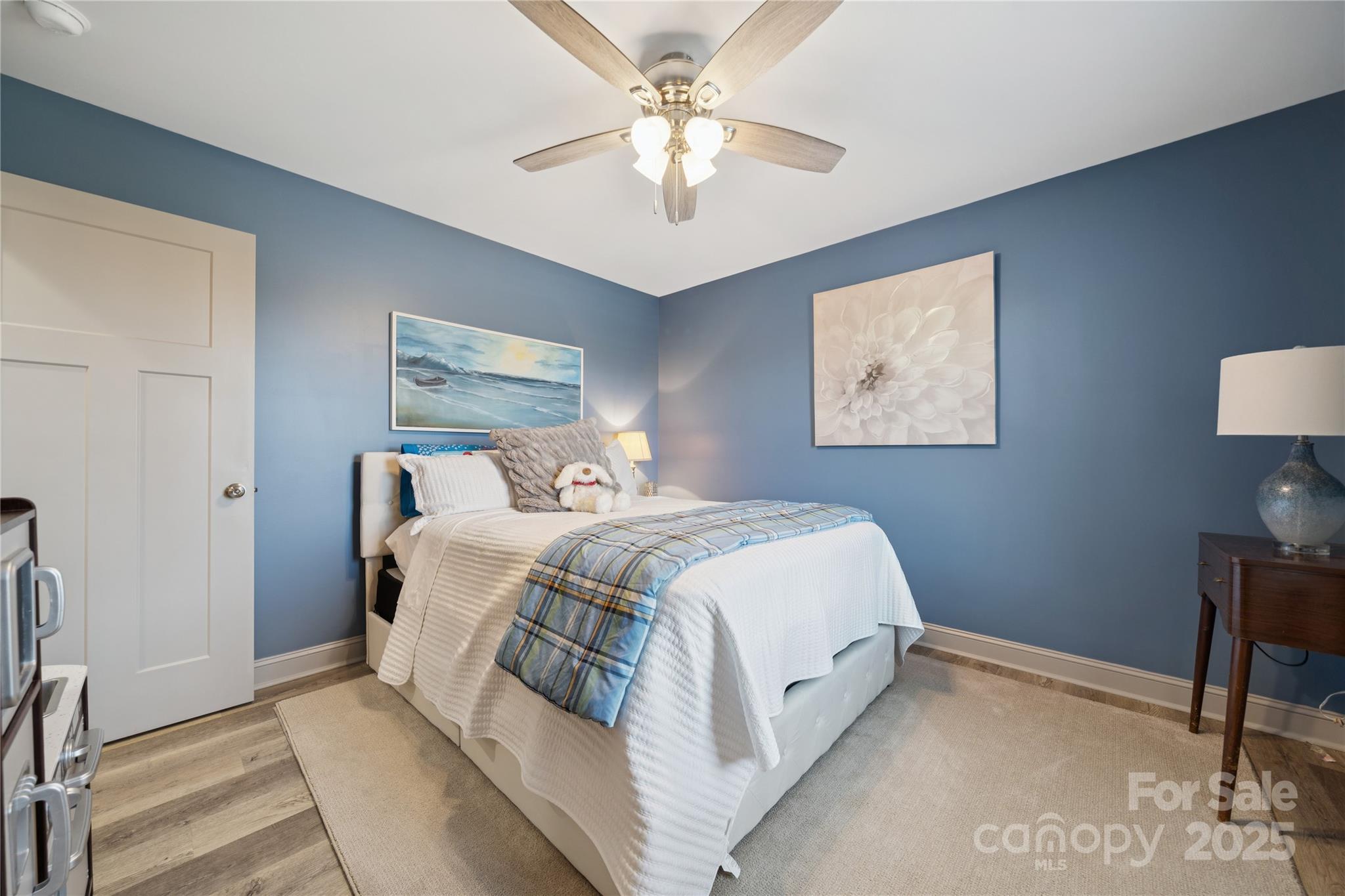 142 Alf Hoover Road Lincolnton, NC 28092 - Photo 28 of 40 a bedroom with a bed and a chandelier