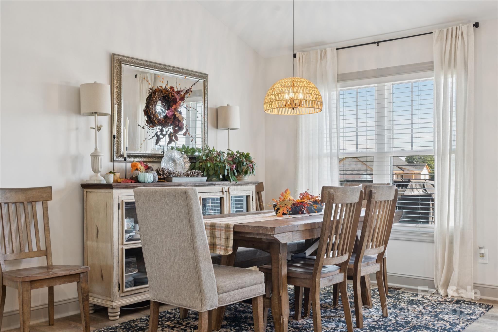 142 Alf Hoover Road Lincolnton, NC 28092 - Photo 29 of 40 a view of a dining room with furniture a chandelier and wooden floor