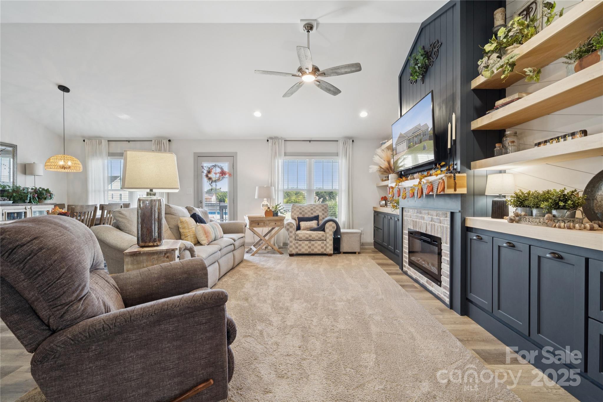 142 Alf Hoover Road Lincolnton, NC 28092 - Photo 5 of 40 a living room with furniture a fireplace and kitchen view