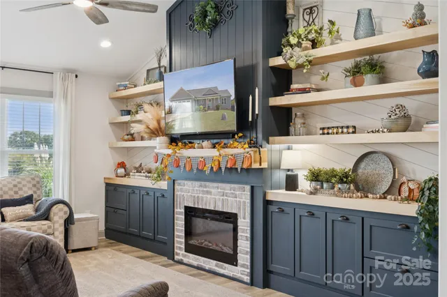 a living room with furniture a fireplace and a flat screen tv